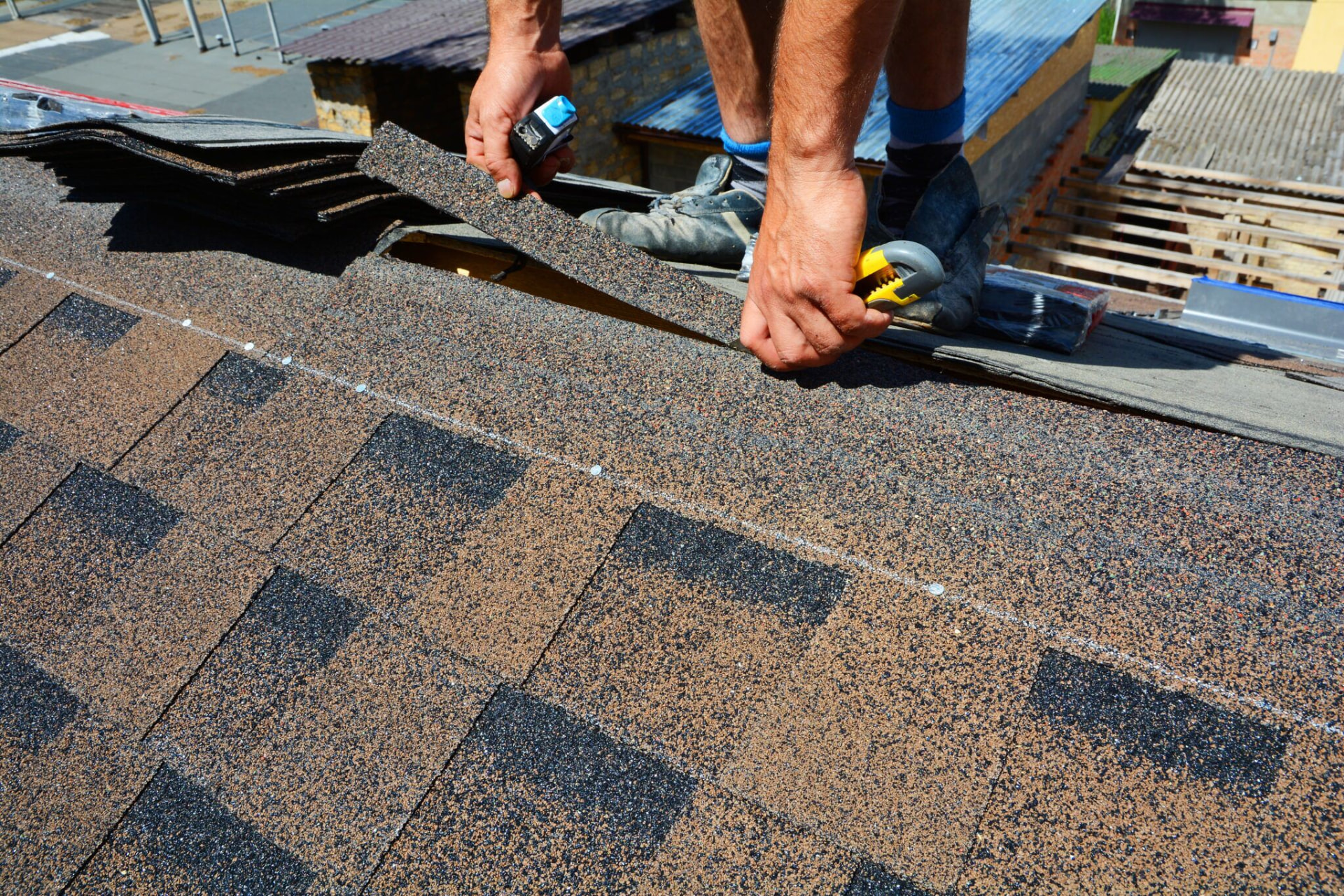 Architectural shingles being laid on a roof