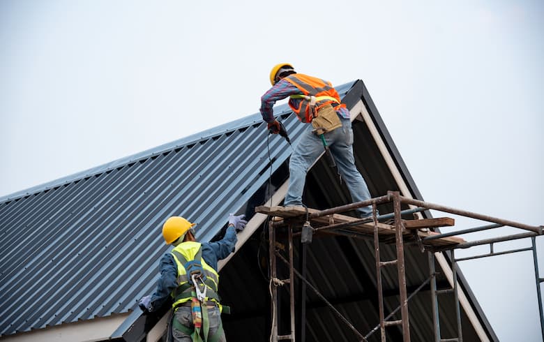 Illustrative roofers working on a residential roof